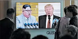  ?? AHN YOUNG-JOON/AP ?? South Koreans view a report in Seoul about leaders Kim Jung Un and President Trump.