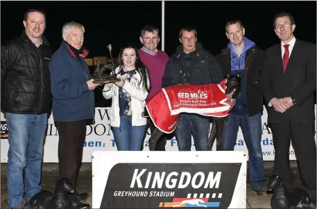  ??  ?? John Geoghegan representi­ng Red Mills presents the winner’s trophy to Orla Twomey after Crossfield Kate won the Red Mills Unraced Bitch Stakes Final at the KGS on Friday. Included, from left, are Kieran Casey, John Twomey, Rafa Depole, winning owner...