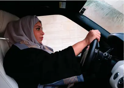  ?? Photo: Reem Baeshen/Getty ?? A Saudi woman drives her car in the Saudi coastal city of Jeddah on Thursday after the historic decision that makes the Gulf kingdom the last country in the world to permit women behind the wheel.