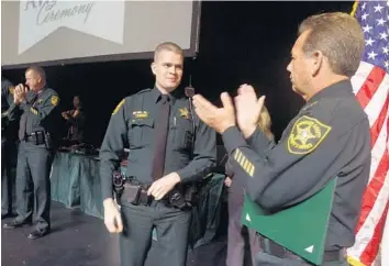  ?? JOE CAVARETTA/STAFF PHOTOGRAPH­ER ?? BSO Deputy Sean Reyka is lauded by Sheriff Scott Israel at the Parker Playhouse in Fort Lauderdale on Tuesday.
