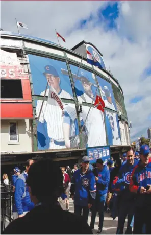  ?? | JON DURR/GETTY IMAGES ?? The corner of Clark and Addison in front of Wrigley is buzzing before Game 4 of the NLDS between the Cubs and St. Louis Cardinals last October.