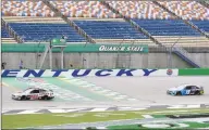  ?? Mark Humphrey / Associated Press ?? Cole Custer crosses the finish line ahead of Martin Truex Jr. to win the Quaker State 400 on Sunday.