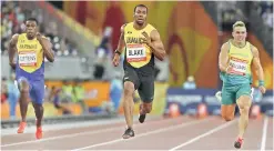  ?? — AP ?? Jamaica’s Yohan Blake (centre) in action at the men’s 100 metres semifinal at the Carrara Stadium on Sunday.