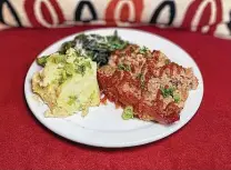  ??  ?? The juicy meatloaf at Candleligh­t Coffeehous­e is served with Caesar salad, sauteed spinach and rich, creamy mashed potatoes.