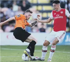  ??  ?? Harry Taylor (left) playing for Barnet against Arsenal.