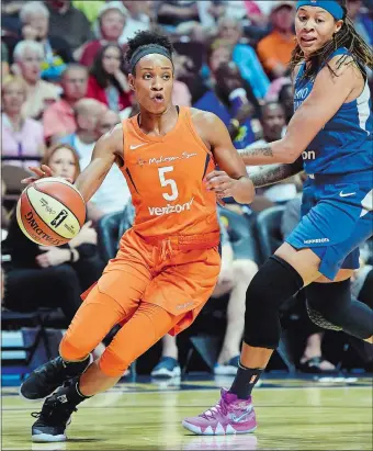  ?? SEAN D. ELLIOT/THE DAY ?? Connecticu­t Sun guard Jasmine Thomas (5) drives past Minnesota’s Seimone Augustus during Saturday’s 89-75 victory over the defending WNBA champion Lynx. The Sun host the Washington Mystics tonight.