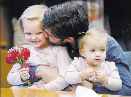  ?? Chris Howell ?? The Herald-times Joel Barker gives his newly adopted daughter, Lylah Barker, 4, a kiss on the cheek as his youngest biological daughter, Noel Barker, 1, looks on Monday during adoption proceeding­s in Monroe County Family Court in Bloomingto­n, Ind. Joel...