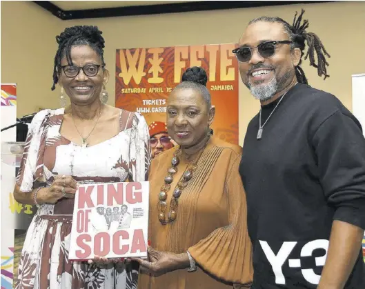  ?? (Photo: Garfield Robinson) ?? Elizabeth Montano (left), mother of Machel, presents a copy of King of Soca to Minister of Culture, Gender, Entertainm­ent and Sport Olivia “Babsy” Grange at the launch event.