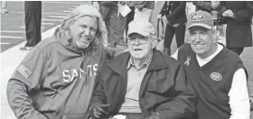  ??  ?? Rob Ryan, left, poses for photograph­s with his father Buddy Ryan, center, and brother Rex Ryan, right, before a Saints-Jets game. BILL KOSTROUN/AP