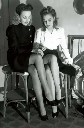  ??  ?? SMALL LUXURIES Models wearing nylon stockings at a fashion display at the Waldorf hotel in London, February 1944