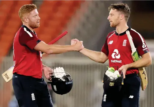  ?? Aijaz Rahi ?? England’s Jonny Bairstow, left, and Jos Buttler celebrate their win in the third Twenty20 cricket match between India and England at Narendra Modi Stadium in Ahmedabad, India on Tuesday