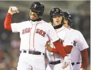  ?? Maddie Meyer / Getty Images ?? Mookie Betts pumps a fist in front of Brock Holt after hitting a grand slam in the sixth inning.
