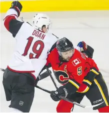  ?? AL CHAREST ?? Arizona Coyotes captain Shane Doan tries to step around captain Mark Giordano on Monday in Calgary. Doan was one of 11 different Coyotes to record a point in Monday night’s game.