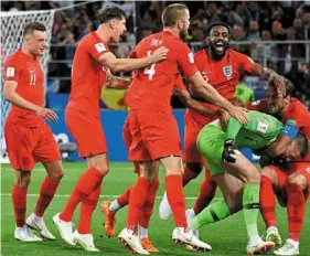  ?? — AFP ?? In ecstasy: england’s Harry Kane (right) celebratin­g with teammates after winning the penalty shootout against Colombia.