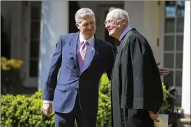  ?? AL DRAGO / THE NEW YORK TIMES ?? Supreme Court Justices Neil Gorsuch (left) and Anthony Kennedy stand in the Rose Garden of the White House in Washington.