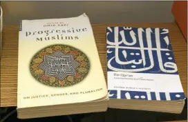  ?? AP PHOTO/DAMIAN DOVARGANES ?? American Muslim Omar Akersim’s books the Progressiv­e Muslim is viewed next to The Quran, the Muslim holy book at his home in Los Angeles Friday, Aug. 1, 2014.