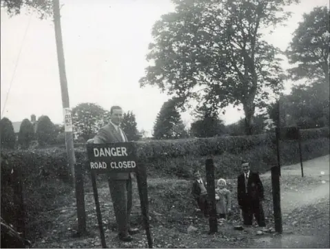  ??  ?? Hard borders are not a new concept in this part of the island, as this 1958 photograph showing the O’Neill family, John, John Junior, Tara and Brian at a then recently closed border crossing at Carricksti­cken in Louth.