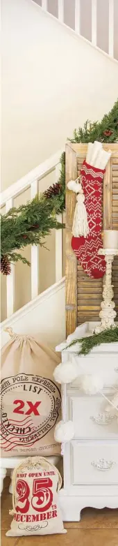  ??  ?? (right) One of the fun aspects of decorating for the holidays is finding ways to incorporat­e aspects of your everyday décor. The entryway has a distinctly farmhouse feel with vintage wooden-slatted shutters combined with a vintage window mirror atop a timeless, white dresser. Annette spruces them up with a small wreath, greenery, stockings and a book-page garland. “I pulled some of the pages off the book wall, rolled them up and stuck them on the garland,” she says.