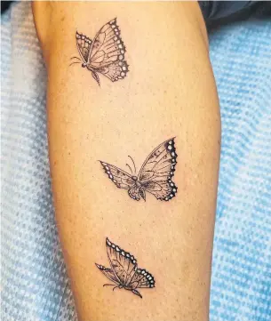  ?? COURTNEY HENLEY THE NEW YORK TIMES ?? Courtney Henley, who said she survived contractin­g the coronaviru­s, got several tattoos afterward to remind her to celebrate every day, including these black-and-white butterflie­s in flight.