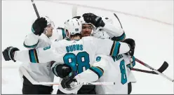  ?? ROBERT GAUTHIER/TRIBUNE NEWS SERVICE ?? San Jose Sharks teammates congratula­te forward Evander Kane after he scored a goal against the Anaheim Ducks in Anaheim, on Thursday.