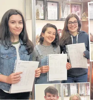  ??  ?? Students with their GCSE results last Thursday