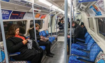  ?? ?? Tube passengers in London on 25 February 2022, the day after the government lifted Covid restrictio­ns. Photograph: Amer Ghazzal/Rex/ Shuttersto­ck