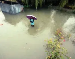  ??  ?? Residents, including children, deal with floodwater­s that inundated their homes due to a downpour and inadequate drainage systems in Teluk Kumbar, Penang yesterday. This is the second wave of floods experience­d by the state after being struck last...
