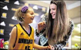  ?? CONTRIBUTE­D BY BRANDEN CAMP ?? Cate Zavitz, 8, talks with KSU basketball player Carlotta Gianolla. The team adopted Zavitz, who has a skin disease, through the Team IMPACT organizati­on.