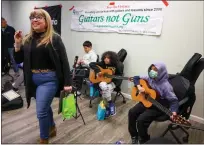  ?? ?? Contra Costa County Supervisor Diane Burgis speaks at the Guitars Not Guns graduation program Wednesday. Burgis' late husband, Richard Clayton, was a volunteer in the program.