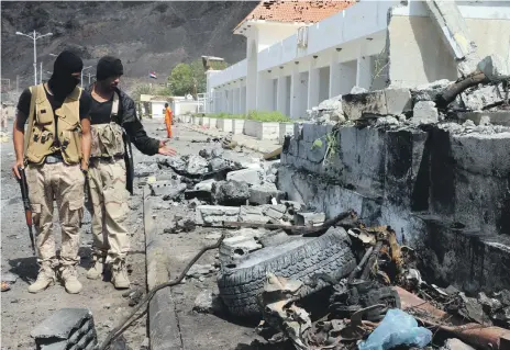  ?? EPA ?? Yemeni troops in the aftermath of a car bomb attack in Aden. Coalition forces have increased counter-insurgency efforts