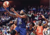  ?? Sean D. Elliot / Associated Press ?? Minnesota Lynx guard Seimone Augustus (33) uses a screen from teammate Sylvia Fowles (34) to get a clear drive to the basket against the Connecticu­t Sun during the first half of a WNBA game in Uncasville in 2018. Augustus has retired from playing and will be an assistant coach for the Los Angeles Sparks, the team announced on Thursday.