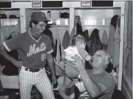  ?? Ray Stubblebin­e / Associated Press ?? Dodgers manager Tom Lasorda, right, lifts up Bobby Valentine, Jr., the four-month-old son of Mets coach Bobby Valentine at Shea Stadium in 1983.