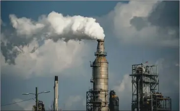  ?? MERIDITH KOHUT — THE NEW YORK TIMES ?? The Securities and Exchange Commission approved new rules Wednesday that place fewer environmen­tal disclosure demands on public businesses than the original proposal made about two years ago. Above, a refinery in Houston.