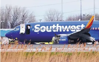  ?? DAVID MAIALETTI/THE PHILADELPH­IA INQUIRER ?? A Southwest Airlines plane sits on a runway at the Philadelph­ia Internatio­nal Airport after it made an emergency landing April 17. The plane landed about 20 minutes after a fan blade broke, shredding the engine and its casing.