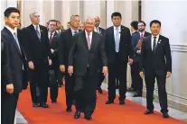  ?? ANDY WONG/POOL VIA THE NEW YORK TIMES ?? Secretary of State Rex Tillerson, center, arrives for a meeting with the Chinese foreign minister Saturday in Beijing. The Trump administra­tion has acknowledg­ed for the first time that it is in direct communicat­ion with the government of North Korea over its missile and nuclear tests.