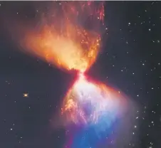  ?? — AFP photo ?? Undated composite handout image from Nasa’s James Webb Space Telescope Near-Infrared Camera (NIRCam) released by Nasa and STScl, shows the Protostar within the dark cloud L1527 with ejections from the star above and below appear orange and blue in infrared view.