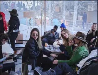  ?? LINDSAY D’ADDATO — THE NEW YORK TIMES ?? Visitors at St. Regis Deer Valley in Park City, Utah, on Jan. 14, 2022. Conditions that are less than ideal ( too little snow in some areas, too much in others) have left would- be skiers to find other forms of winter revelry.