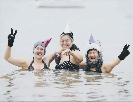  ??  ?? POPULAR Swimmers enjoy the Gafirs' New Year's Day Swim at Stokes Bay in Gosport in 2020