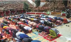  ?? Reuters ?? ■ Muslim men attend Friday prayers at an area affected by Monday’s earthquake in Cianjur, West Java province.