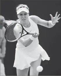  ?? Associated Press photo ?? Eugenie Bouchard of Canada plays a return to Ashleigh Barty of Australia during their women's singles match on the fourth day at the Wimbledon Tennis Championsh­ips in London, Thursday.