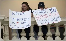  ?? BEN GRAY — THE ASSOCIATED PRESS ?? Protesters inside the State Capitol in Atlanta back changes in Georgia’s voting laws as the Legislatur­e meets Monday. The state Senate has voted to limit access to absentee ballots.