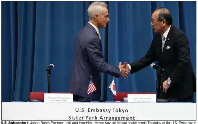  ?? (AP/Eugene Hoshiko) ?? U.S. Ambassador to Japan Rahm Emanuel (left) and Hiroshima Mayor Kazumi Matsui shake hands Thursday at the U.S. Embassy in Tokyo after signing a sister park arrangemen­t between the Pearl Harbor National Memorial and the Hiroshima Peace Memorial Park.