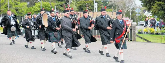  ??  ?? The Dannevirke Highland Pipe Band marches into Totara College last Saturday morning, heralding the opening of the annual garden and craft expo.