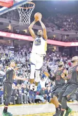  ?? — AFP photo ?? Kevin Durant of the Golden State Warriors goes up for a slam dunk against the Cleveland Cavaliers during an NBA basketball game at ORACLE Arena on December 25, 2017 in Oakland, California.