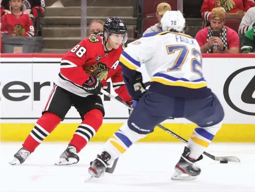  ?? GETTY IMAGES ?? Patrick Kane looks to get off a shot as the Blues’ Justin Faulk defends him during the Blackhawks’ 6-3 preseason loss Friday at the United Center.
