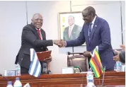  ?? ?? Vice President Kembo Mohadi and his counterpar­t, Cuban Vice President Salvador Valdes Mesa shake hands during the exchange of signed MOU on exemption of Visa requiremen­ts to diplomatic, official and service passports at Munhumutap­a Building