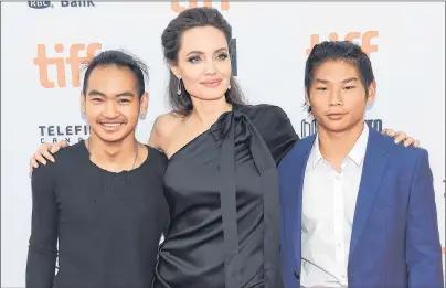  ?? EVAN AGOSTINI VIA THE ASSOCIATED PRESS ?? Maddox Jolie-Pitt, from left, Angelina Jolie and Pax Jolie-Pitt were at the Toronto Internatio­nal Film Festival Monday for a premiere for “First They Killed My Father,” a movie about the Khmer Rouge era in Cambodia. Maddox was born in Cambodia and has...