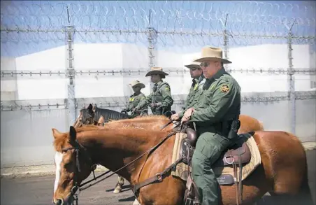  ?? Sandy Huffaker/Getty Images ?? Mounted Border Patrol agents patrol along the U.S.-Mexico border during a media tour with Homeland Security chief John Kelly and Attorney General Jeff Sessions at Brown Field Station on Friday in Otay Mesa, Calif.