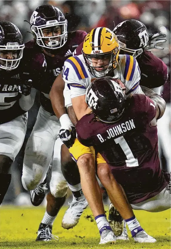  ?? SamCraft / Associated Press ?? A&M’s Buddy Johnson sacks LSU’s Max Johnson in the first half Saturday in College Station. The Aggies’ defense kept the Tigers’ scoreless until the fourth quarter.