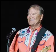  ?? AP PHOTO/DANNY JOHNSTON, FILE ?? This September 2012 photo shows singer Glen Campbell performing during his Goodbye Tour in Little Rock, Ark. Campbell, the grinning, high-pitched entertaine­r who had such hits as "Rhinestone Cowboy" and spanned country, pop, television and movies, died...